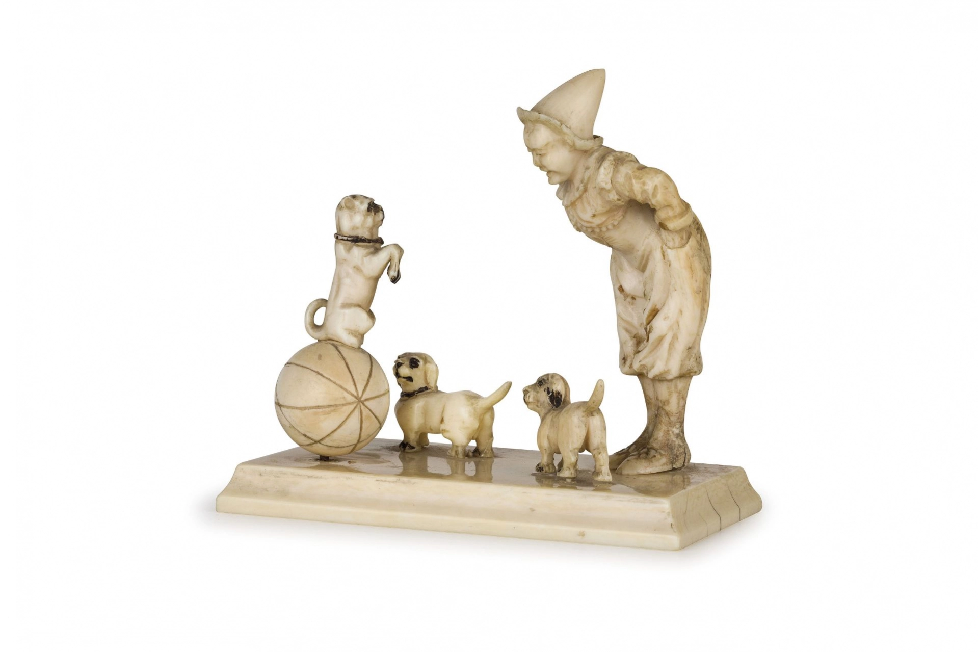 Figurine d'un clown oriental avec des chiens.
