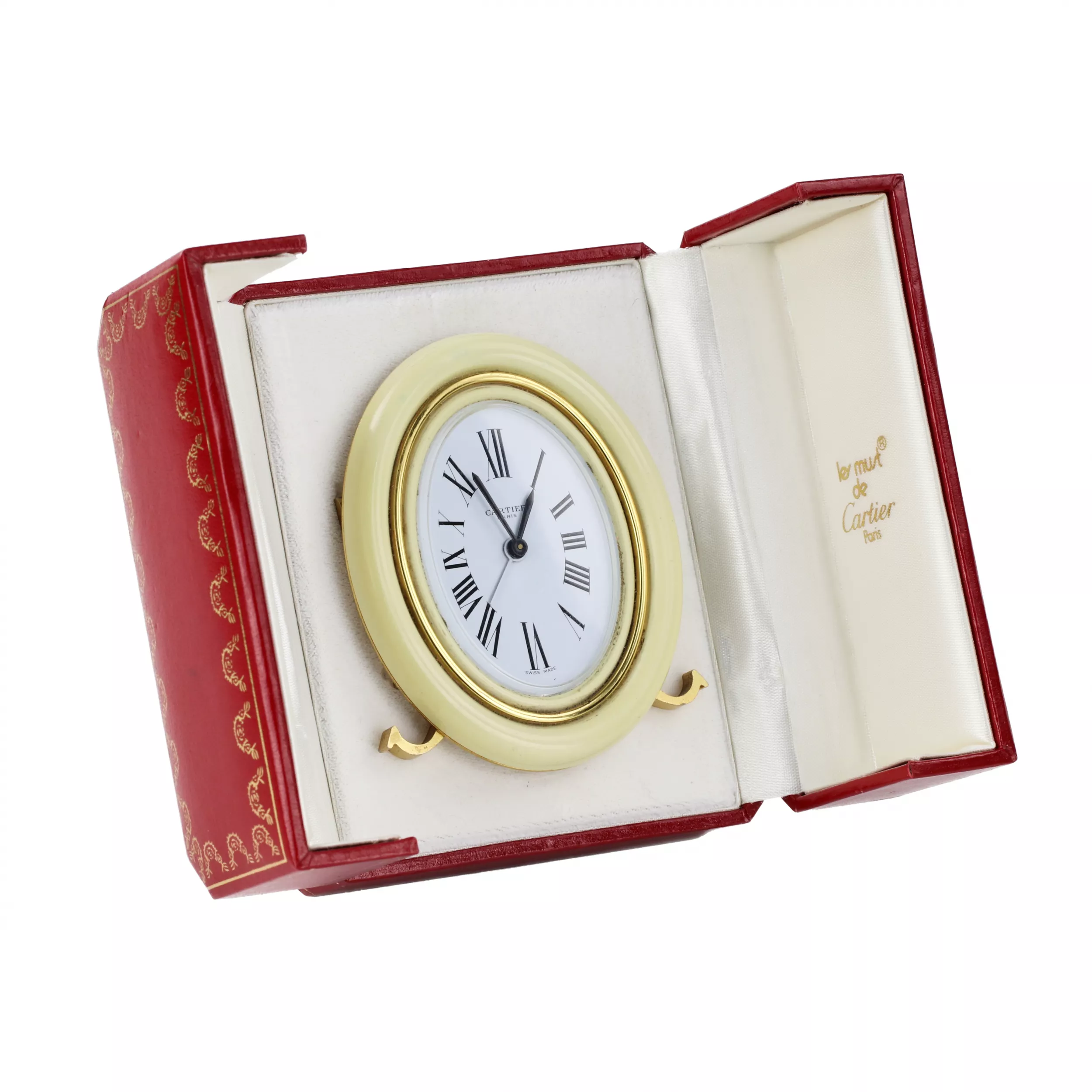 CARTIER. Reveil de voyage en metal dore avec email. 