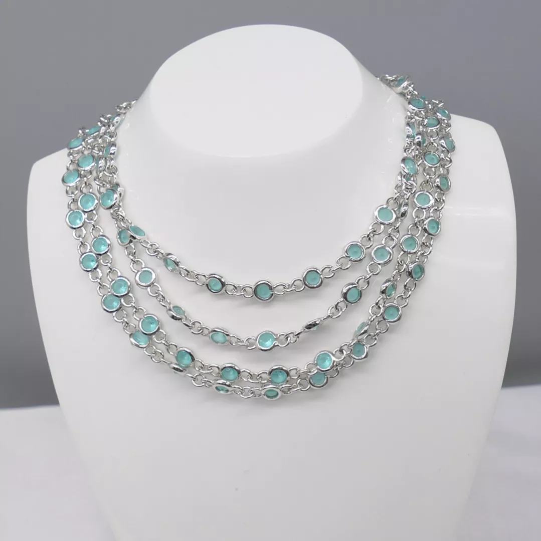 Delightful long necklace in sterling silver with turquoise blue stones. 