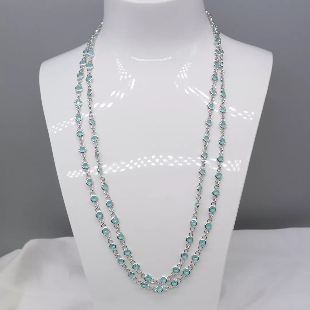 Delightful long necklace in sterling silver with turquoise blue stones. 