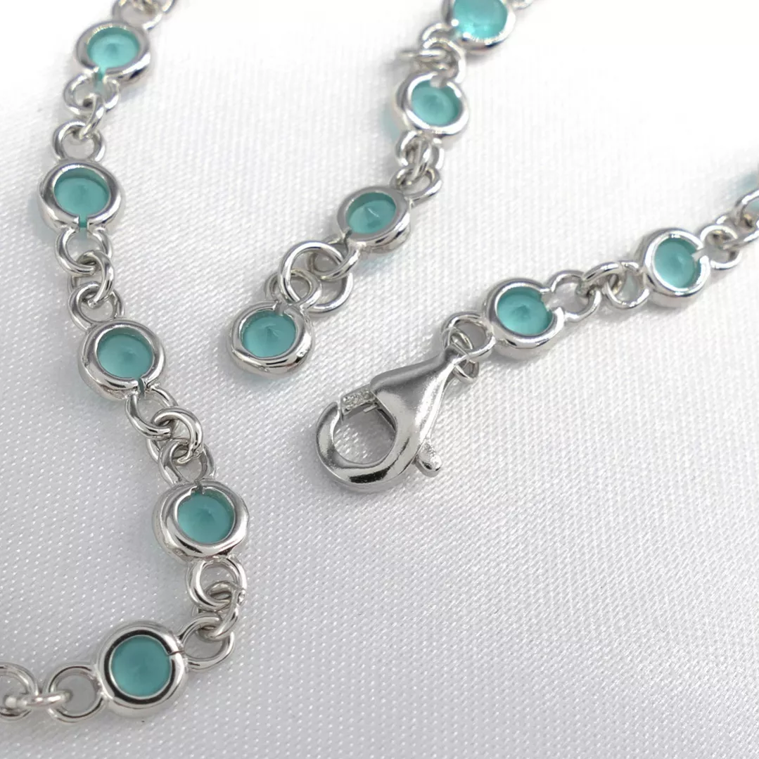 Delightful long necklace in sterling silver with turquoise blue stones. 