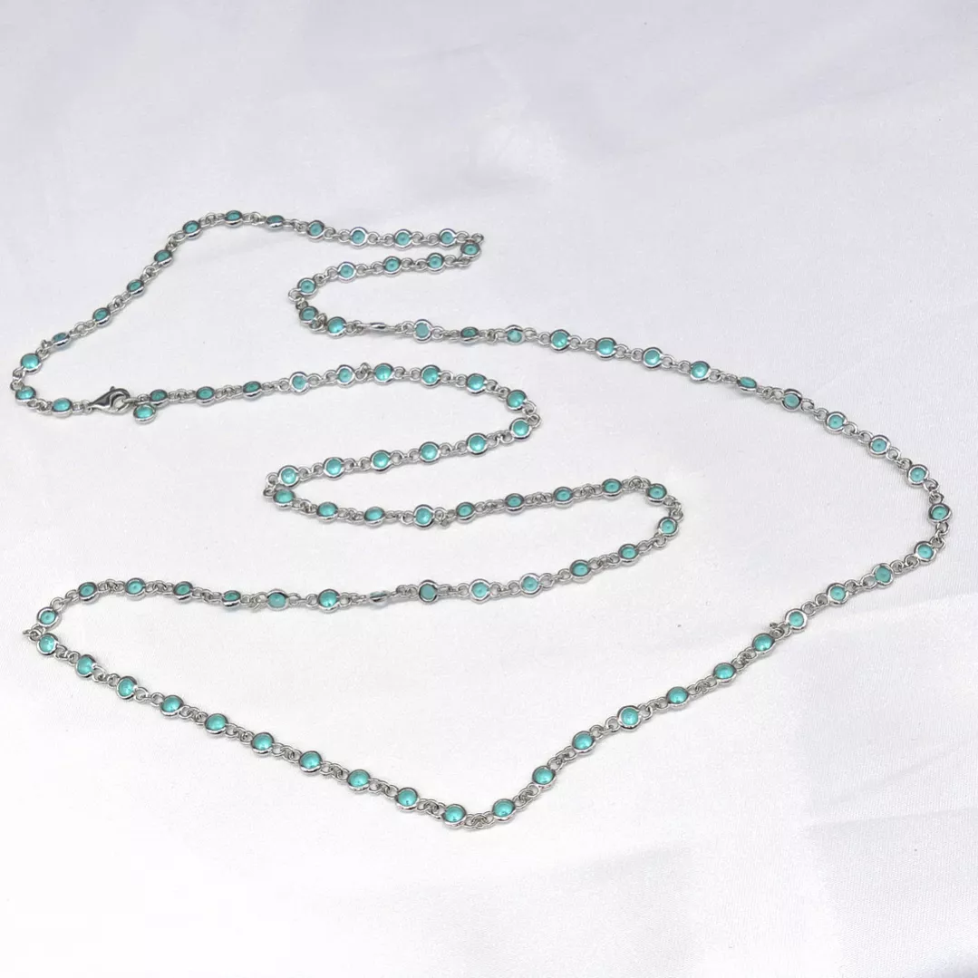 Delightful long necklace in sterling silver with turquoise blue stones. 