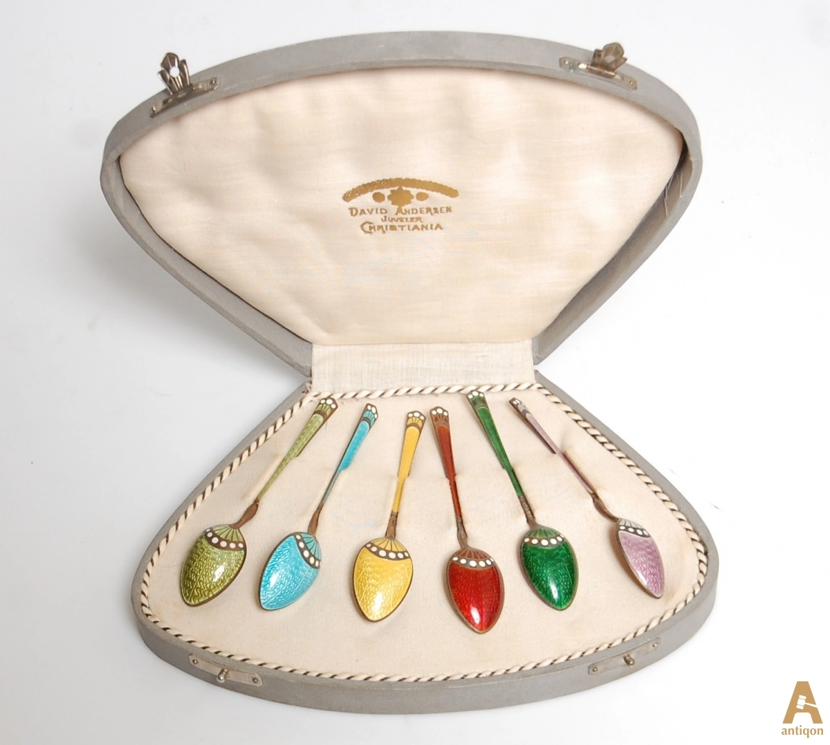 A set of silver spoons with enamel