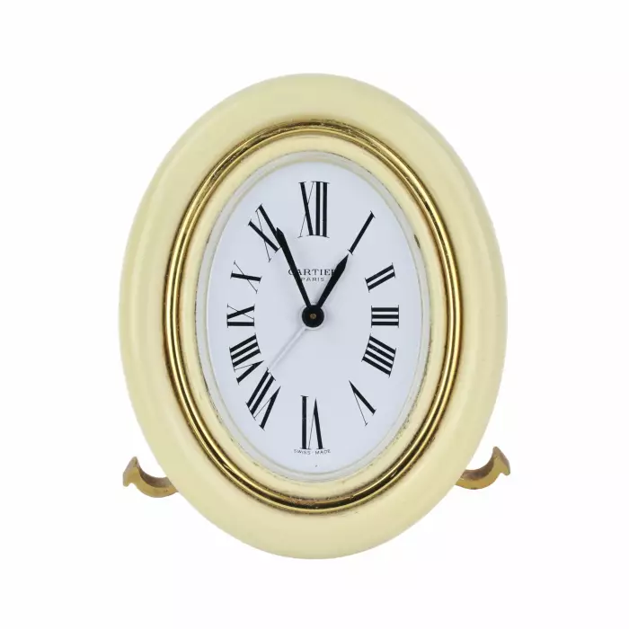 CARTIER. Reveil de voyage en metal dore avec email. 