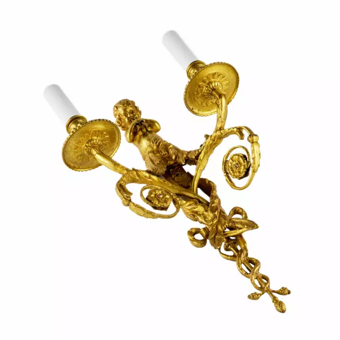Four intricate gilded sconces with currency curls crowned with cherubs. 