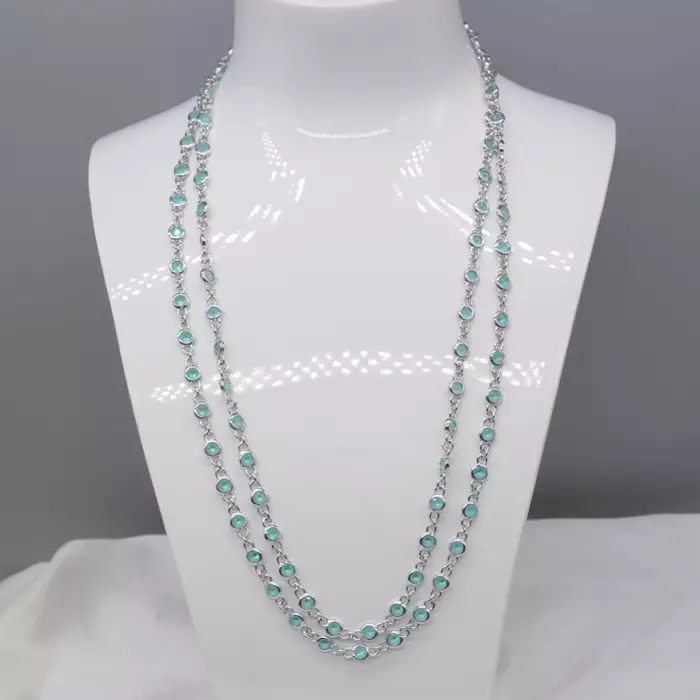 Delightful long necklace in sterling silver with turquoise blue stones. 