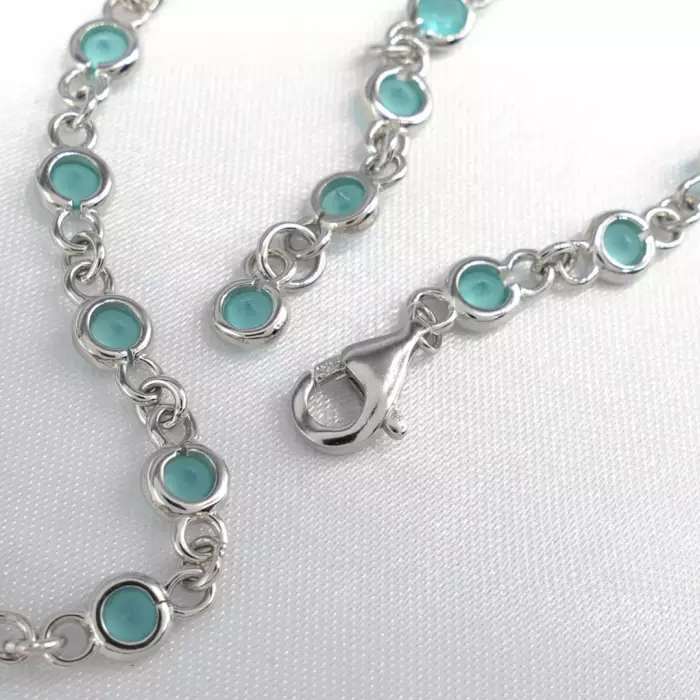 Delightful long necklace in sterling silver with turquoise blue stones. 