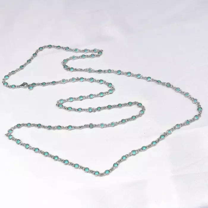 Delightful long necklace in sterling silver with turquoise blue stones. 