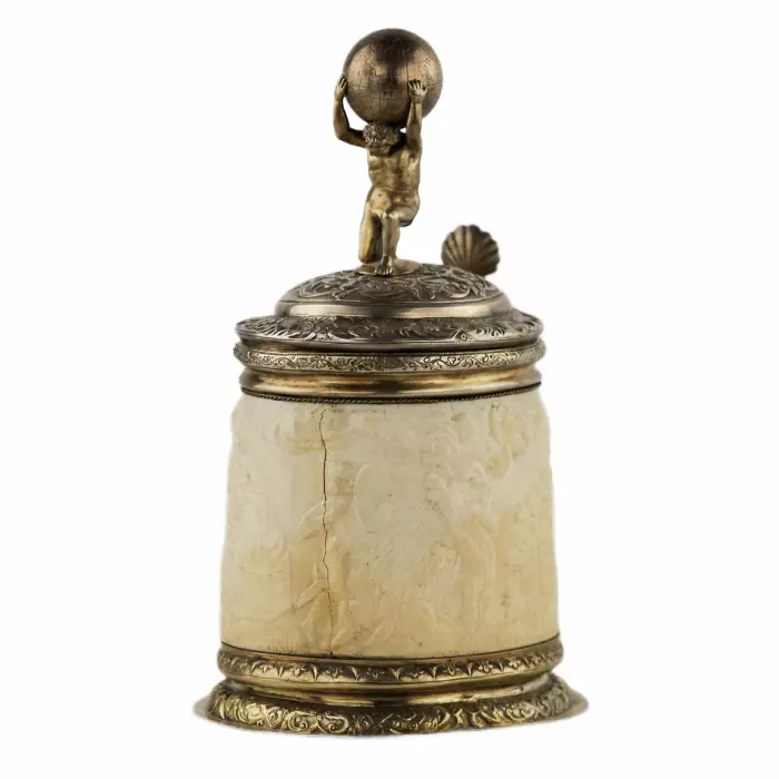 Silver beer goblet with Atlas on the lid and religious scenes on ivory. Lubeck. 17th century. 