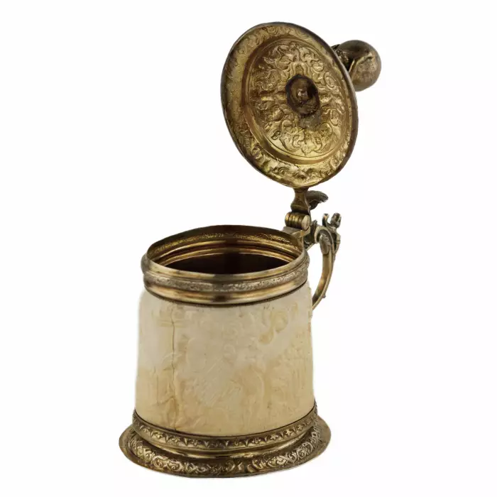 Silver beer goblet with Atlas on the lid and religious scenes on ivory. Lubeck. 17th century. 