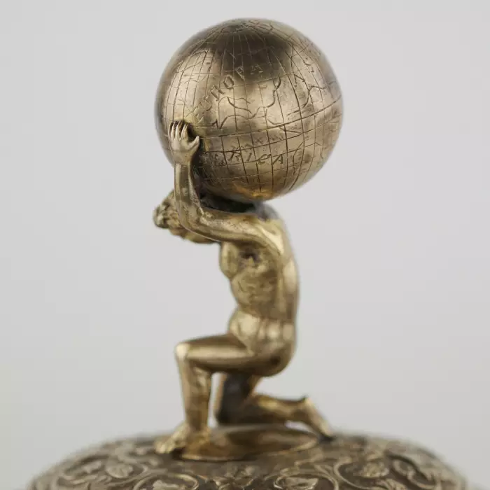 Silver beer goblet with Atlas on the lid and religious scenes on ivory. Lubeck. 17th century. 