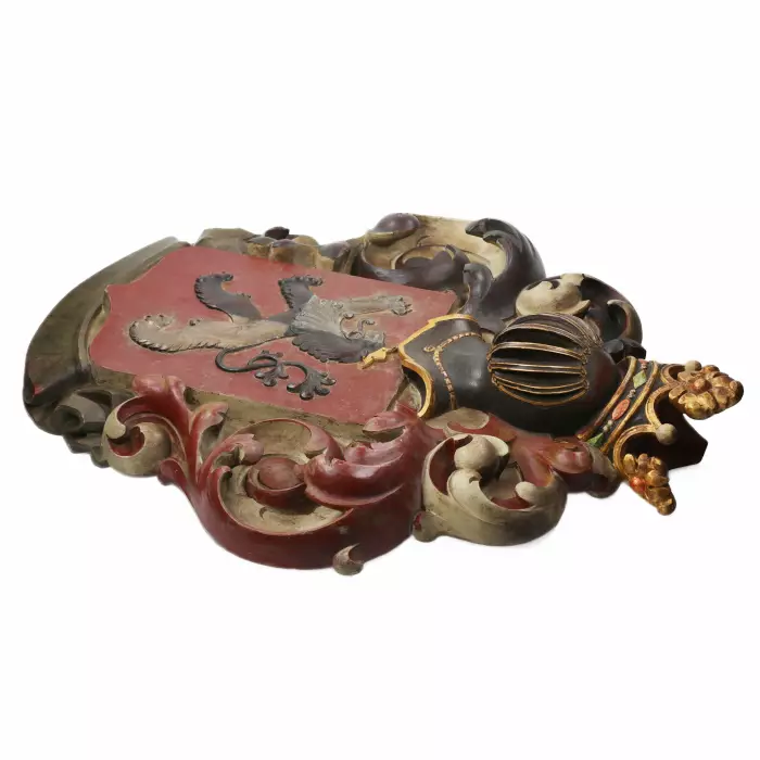 Large, carved, wooden coat of arms depicting a knight`s helmet topped with a crown. 19th century. 
