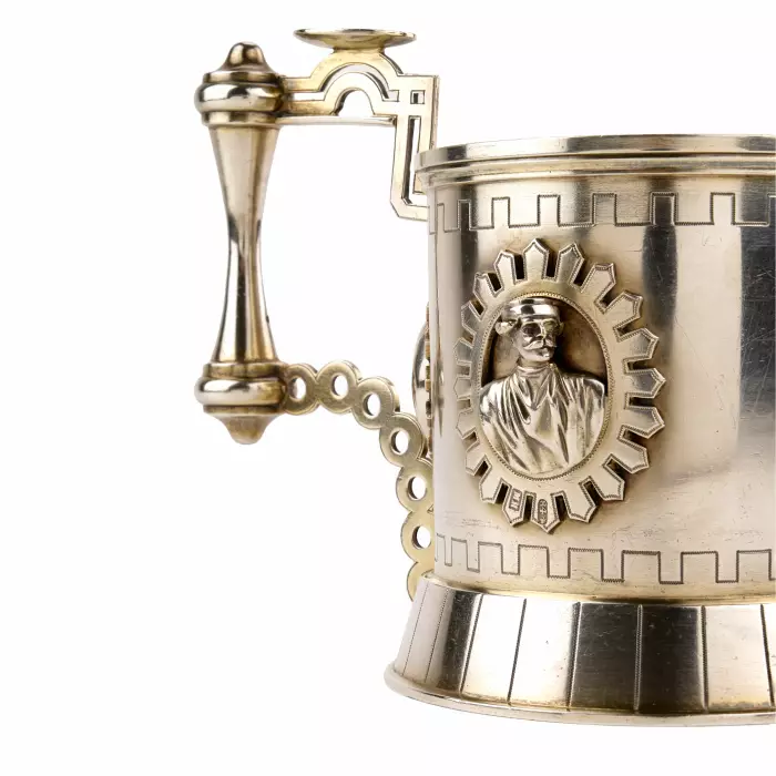 SILVER TEA GLASS HOLDER WITH RELIEF MEDALLIONS IN THE NEO-RUSSIAN STYLE. ST PETERSBURG, 1879