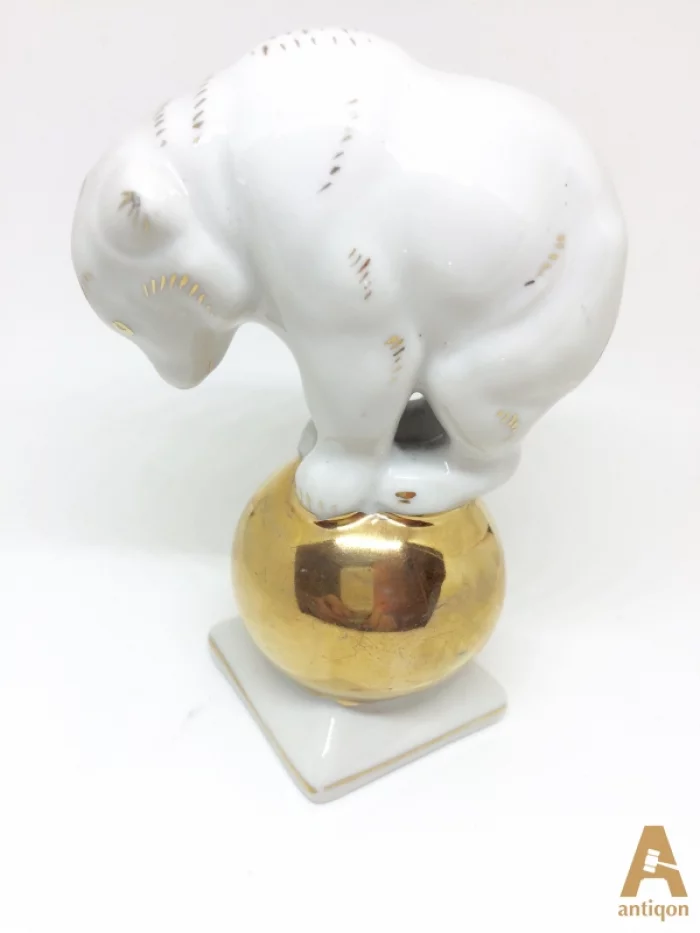 Polar bear on golden ball