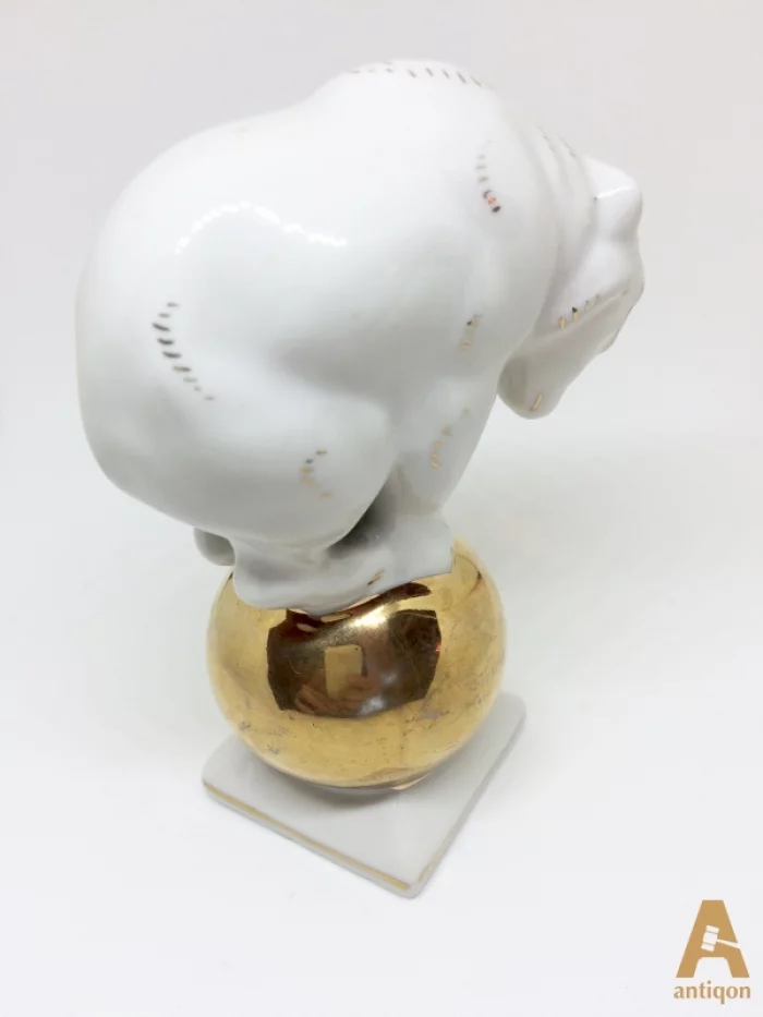 Polar bear on golden ball