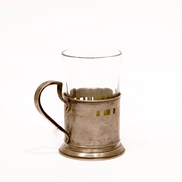 Silver cup holder with a glass.