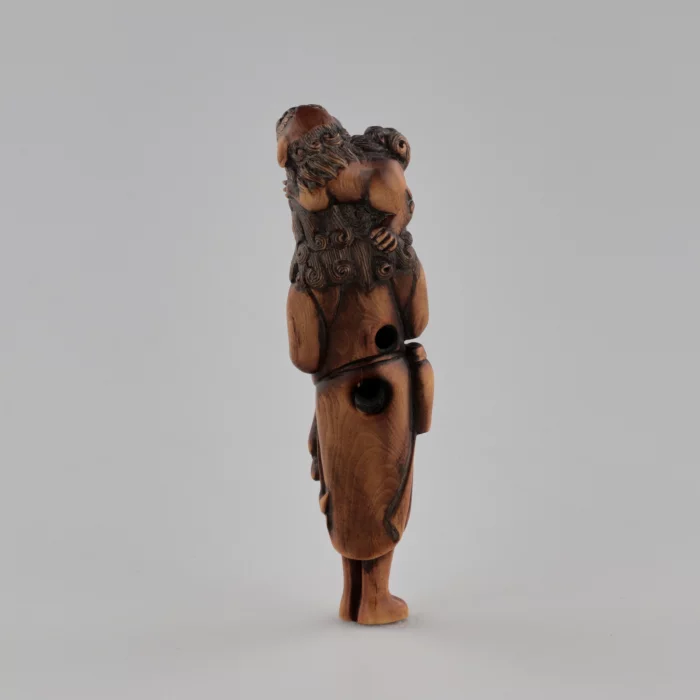 Netsuke en bois Voyageur avec un chien sur la tête style Tadakazu 1819 siècle.