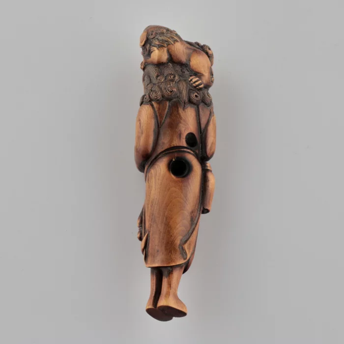 Netsuke en bois Voyageur avec un chien sur la tête style Tadakazu 1819 siècle.
