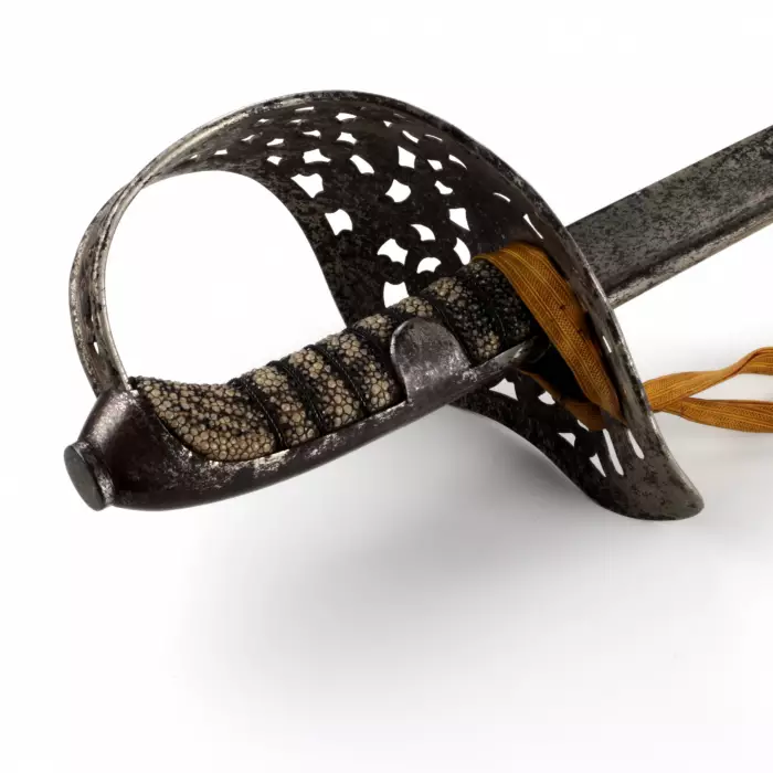 A cavalry broadsword with a carved steel hilt. 