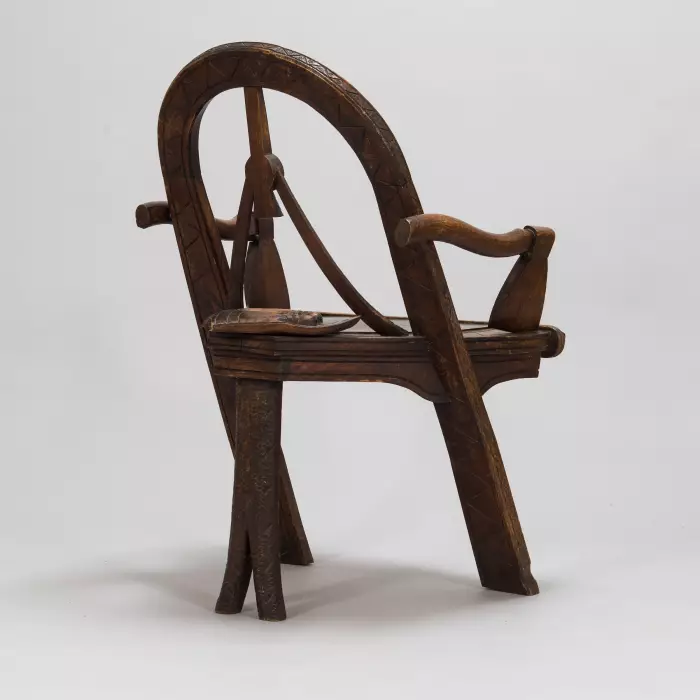 Russian carved armchair Arch, ax and gloves according to the sketch of V.P. Shutov. Russia, late 19th century. 