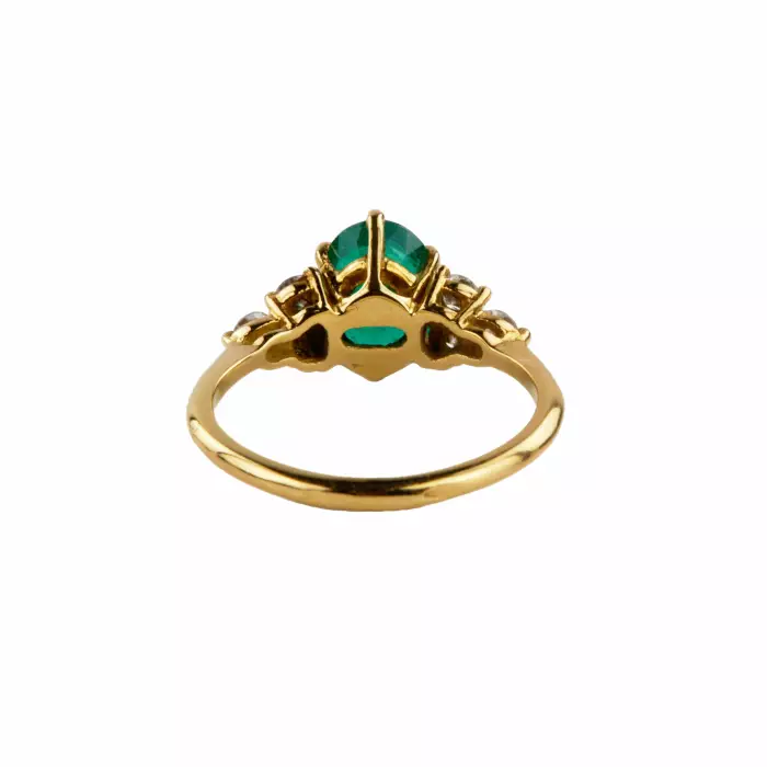Gold ring with emerald and diamonds. 