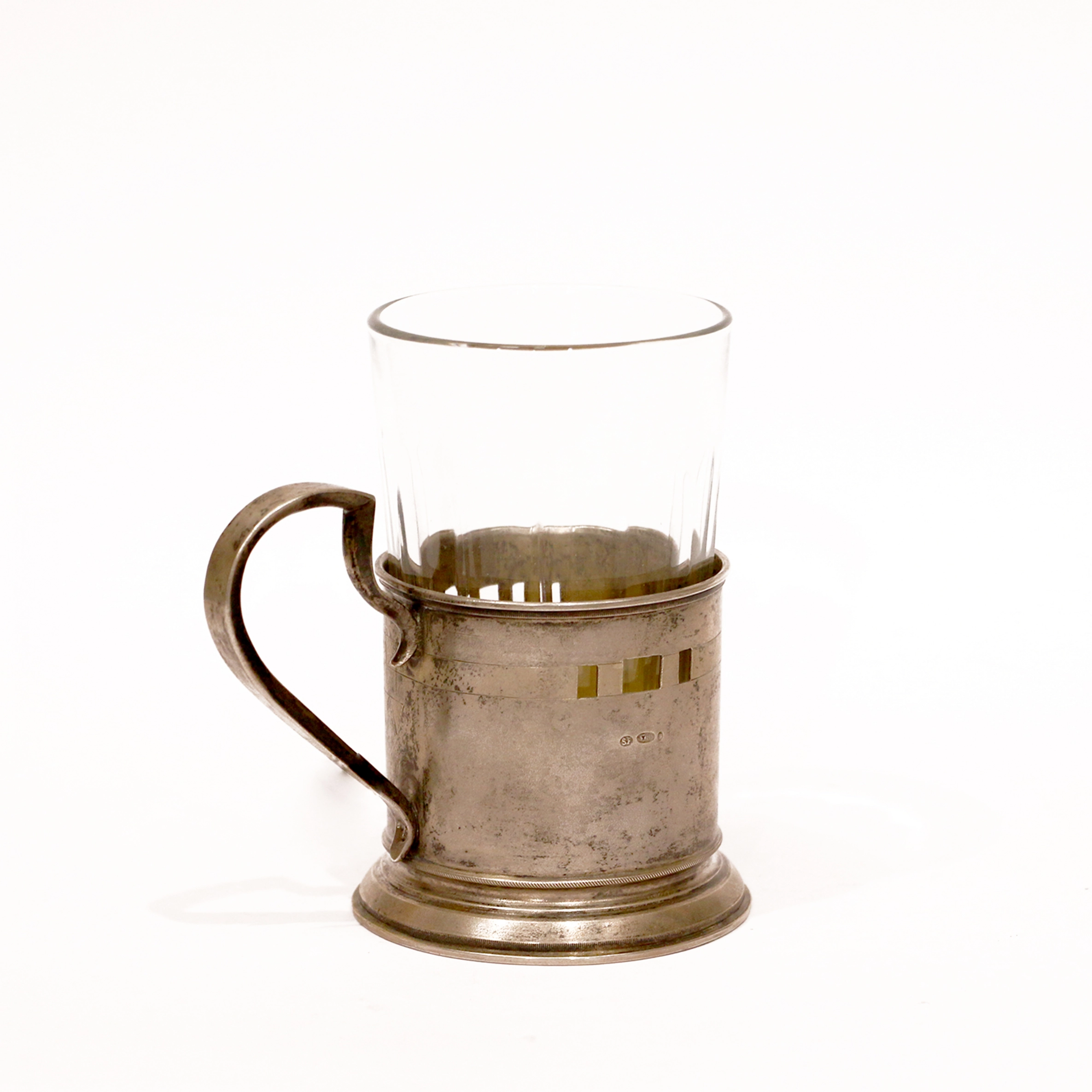 Silver cup holder with a glass.