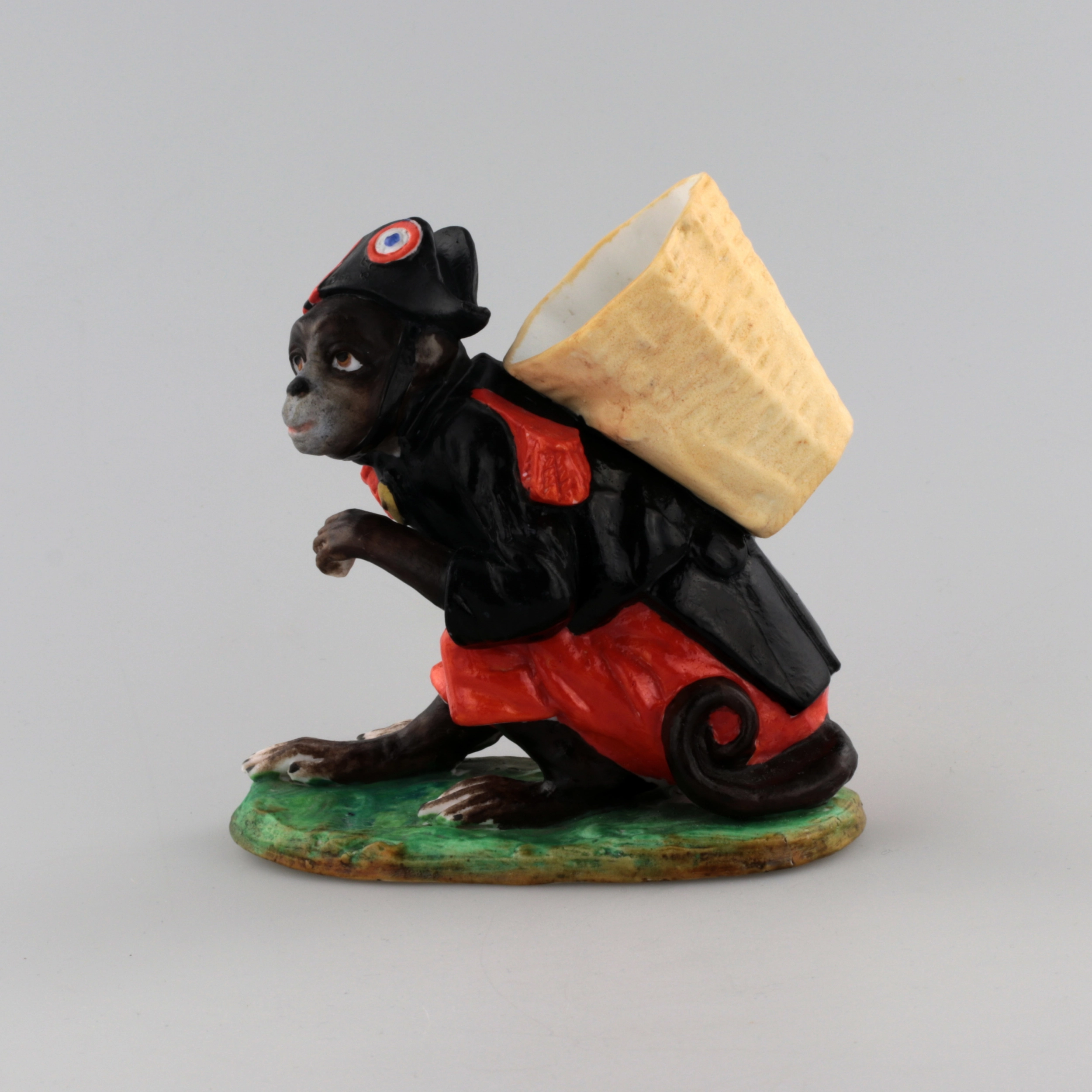 PORCELAIN FIGURE-CONTAINER MONKEY AS NAPOLEON. THURINGIA, GERMANY. LATE 19TH TO EARLY 20TH CENTURY.