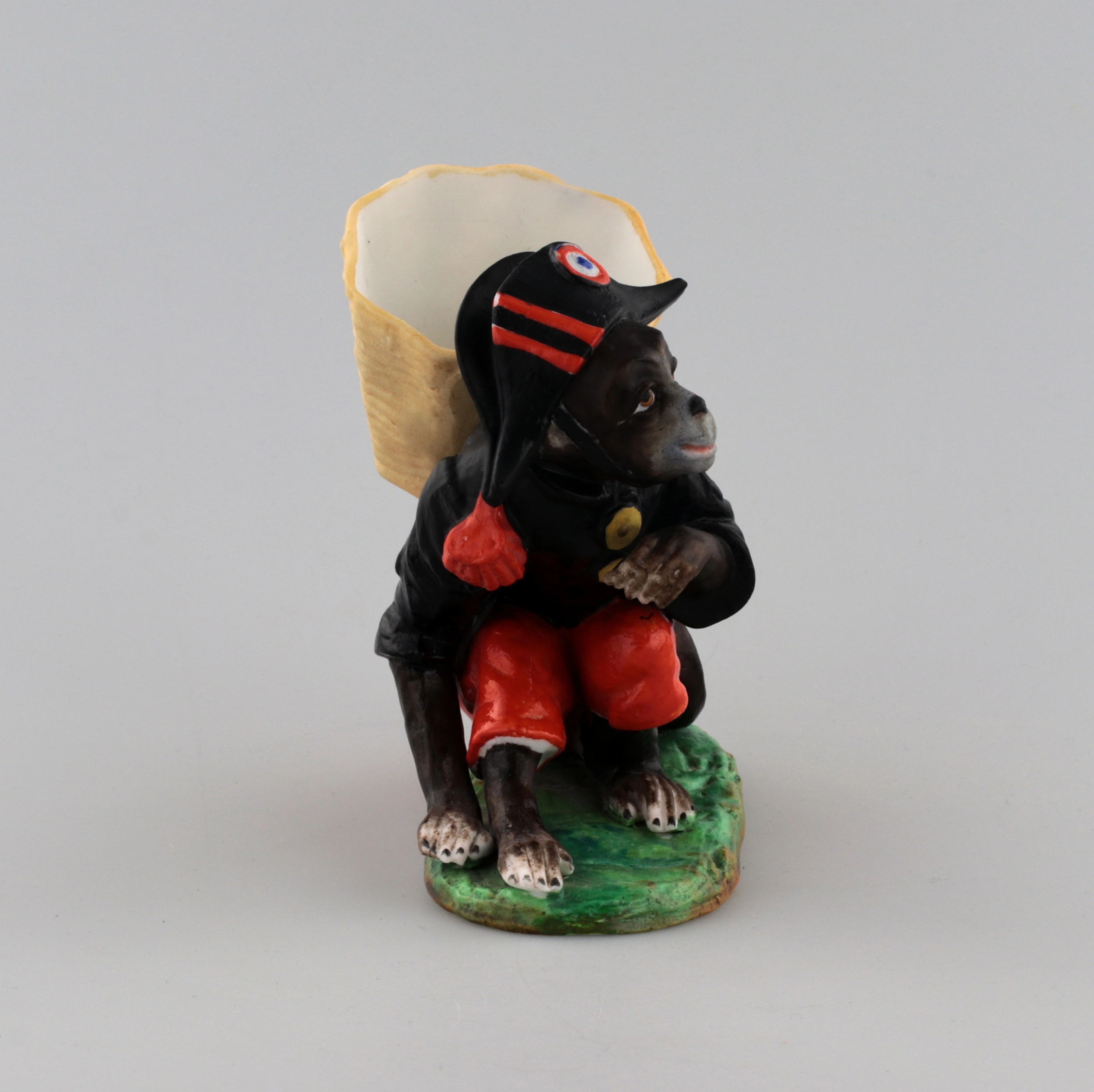 PORCELAIN FIGURE-CONTAINER MONKEY AS NAPOLEON. THURINGIA, GERMANY. LATE 19TH TO EARLY 20TH CENTURY.
