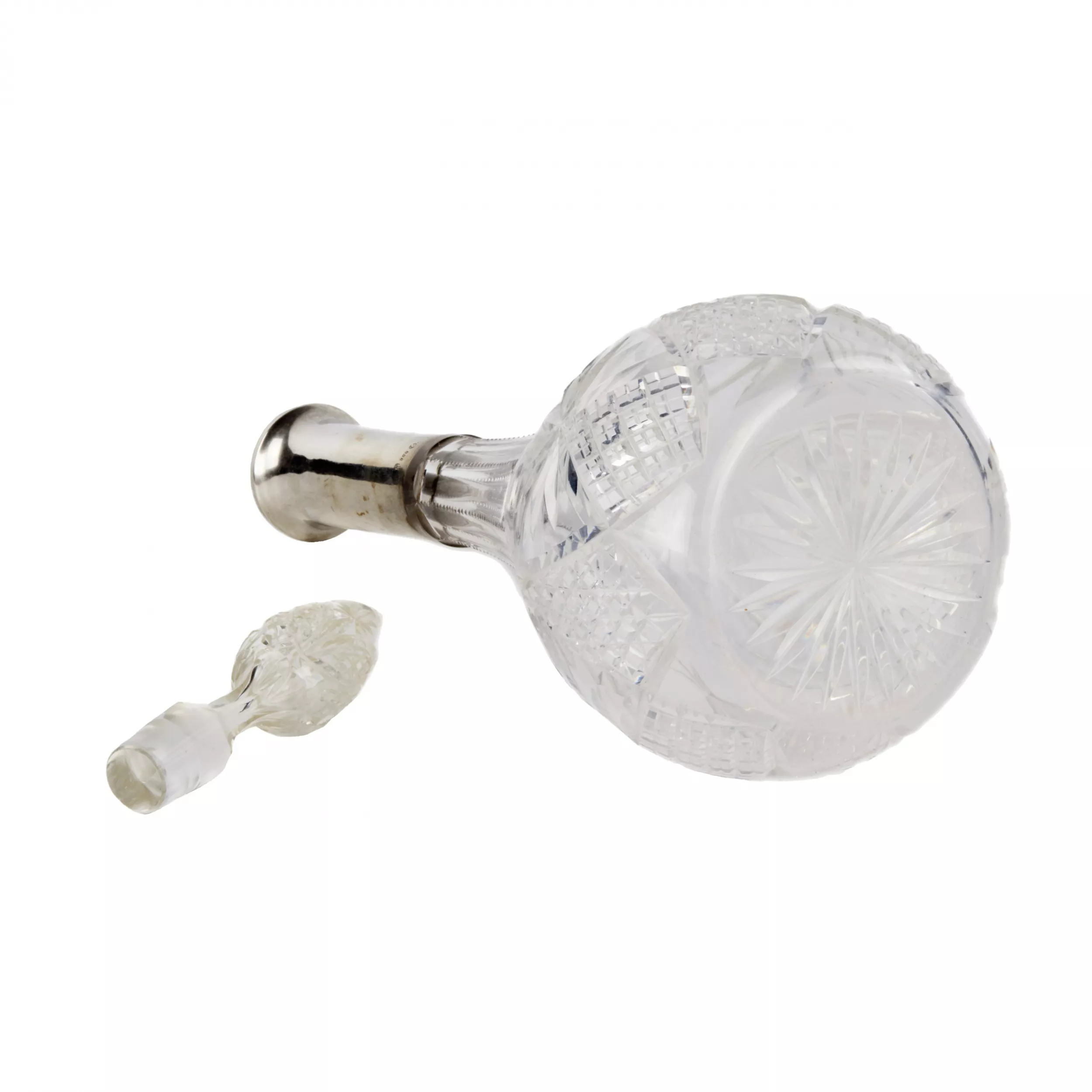 Crystal decanter with a silver neck. 