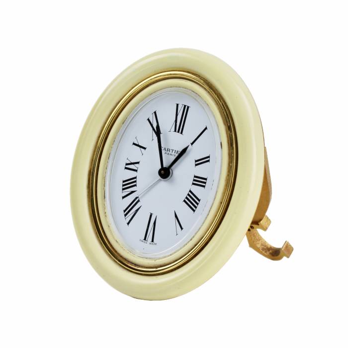 CARTIER. Travel alarm clock made of gilded metal with enamel. 