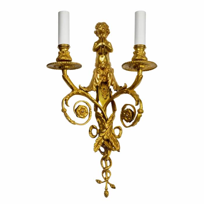 Four intricate gilded sconces with currency curls crowned with cherubs. 