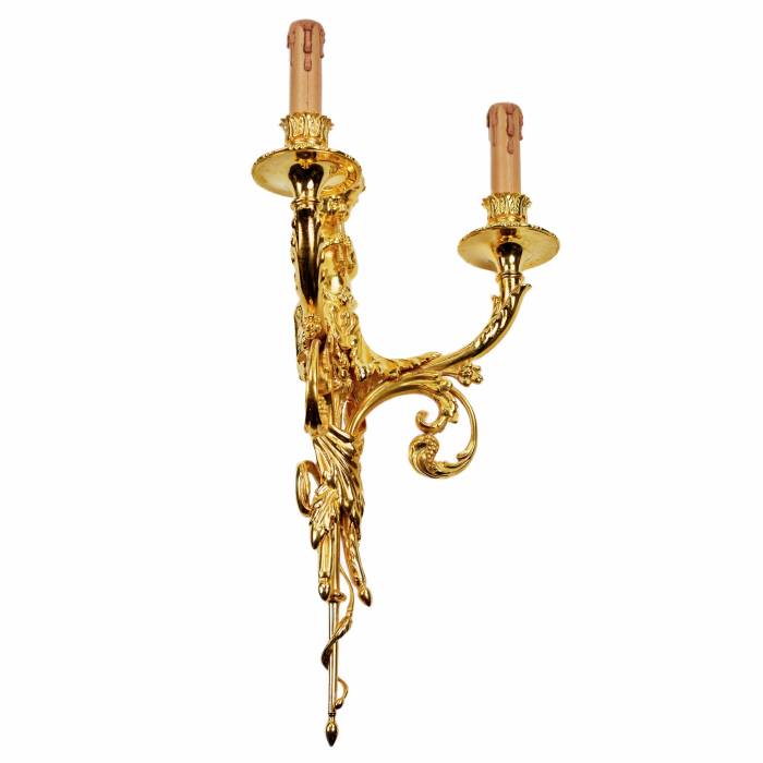 A pair of gilded sconces, with currency curls, surmounted by cherubs. 