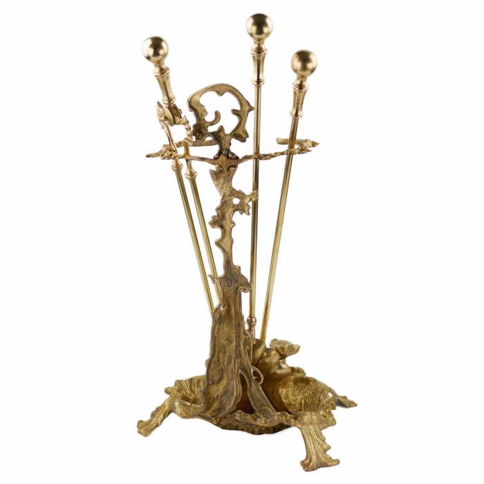 Brass-bronze fireplace set in historicist style. 19-20th centuries. 