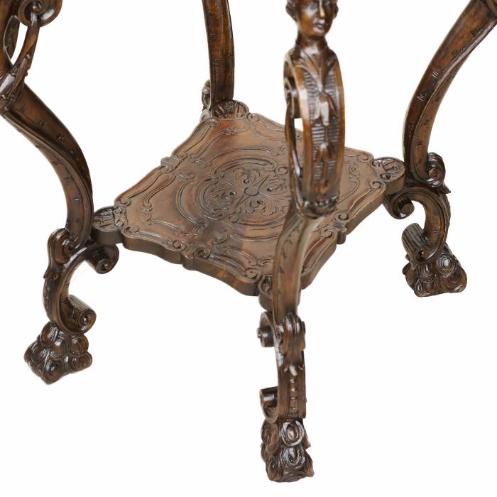 Carved wooden table in neo-Rococo style from the turn of the 19th century.