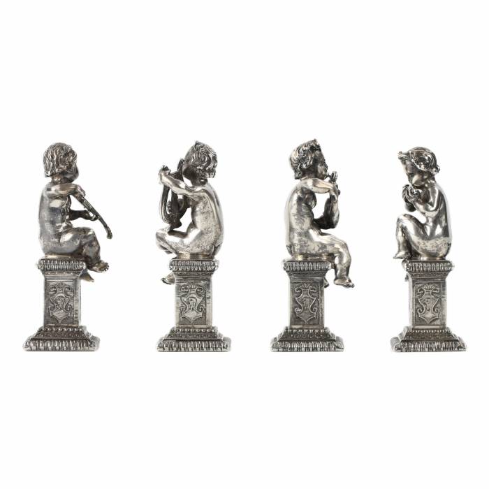 Four funny figures of putti musicians in silver. 