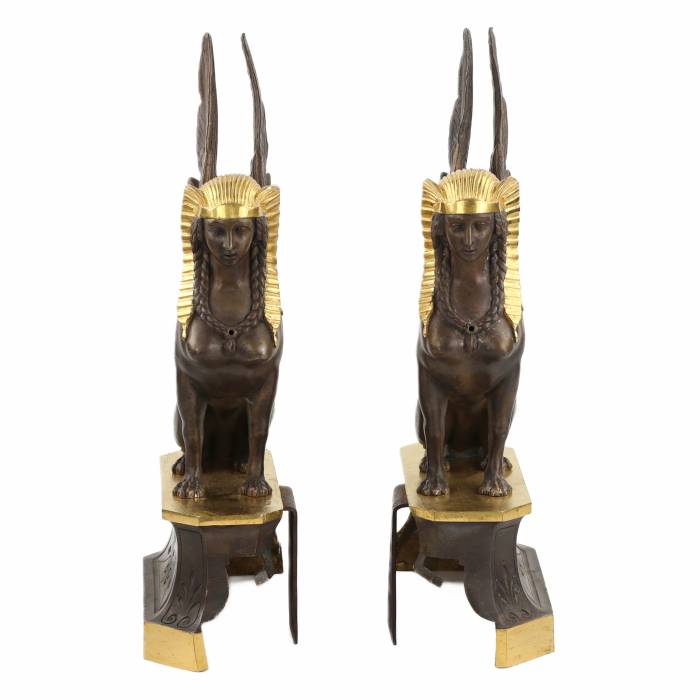 A pair of patinated and gilded bronze firewood stands in the shape of winged sphinxes. 19th century. 