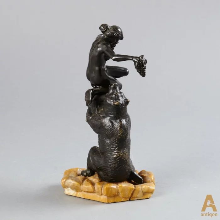 "The bear and female figure with grapes