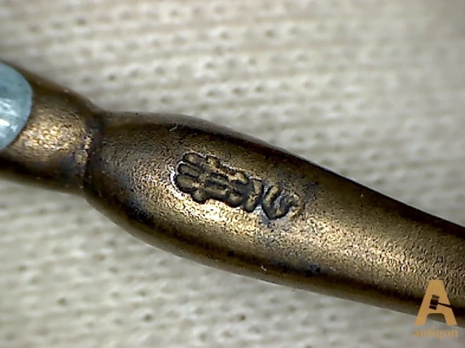 A set of silver spoons with enamel