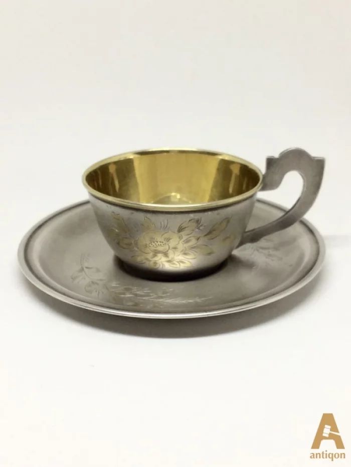 Silver cup with a saucer
