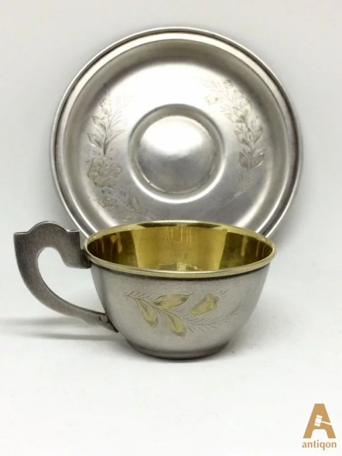 Silver cup with a saucer