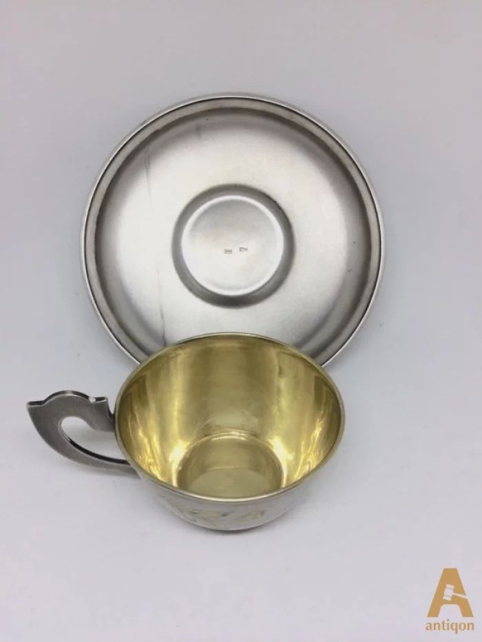 Silver cup with a saucer