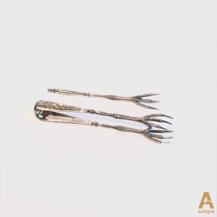 A fabulous set of silver sugar tongs and a lemon fork.