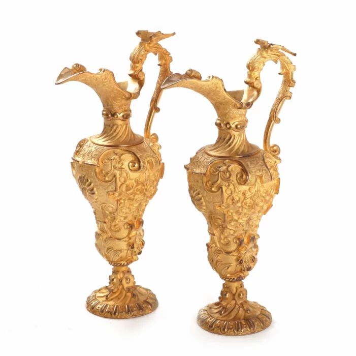 A pair of decorative gilded jugs. 