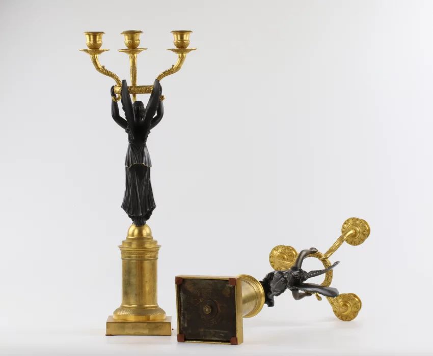 A pair of bronze candlesticks in Empire style