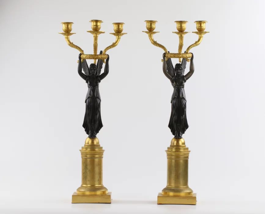 A pair of bronze candlesticks in Empire style