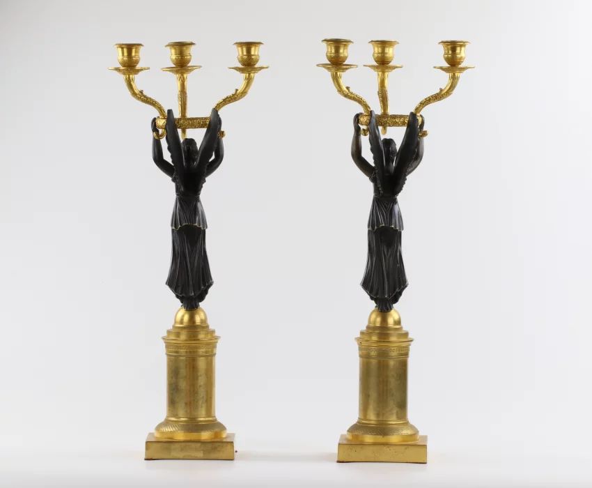 A pair of bronze candlesticks in Empire style