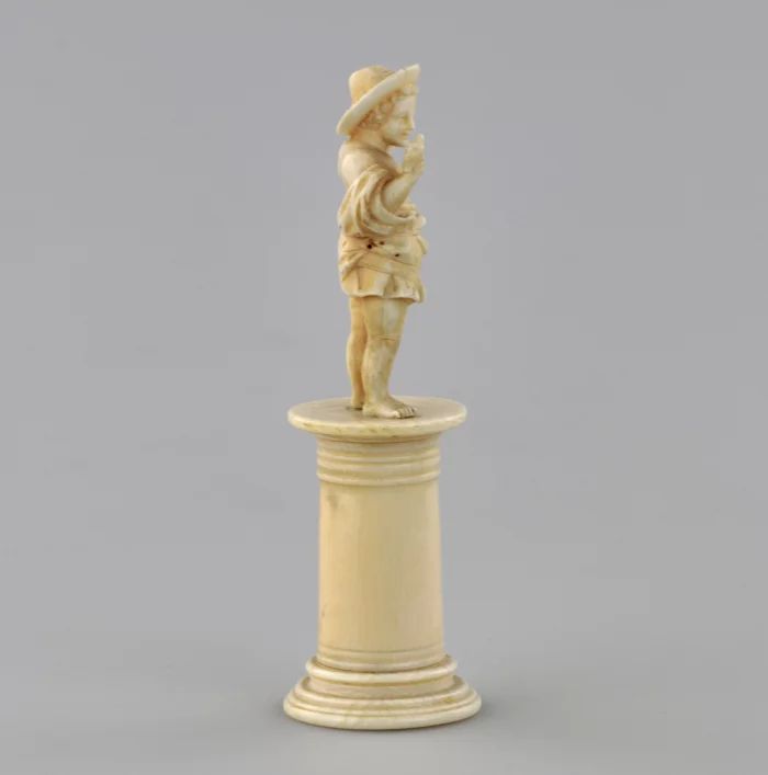 Carved ivory figurine of a boy with a bird 1800s.