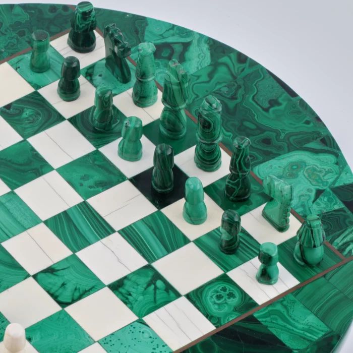 Malahīta šahs uz apaļa spēļu galda 