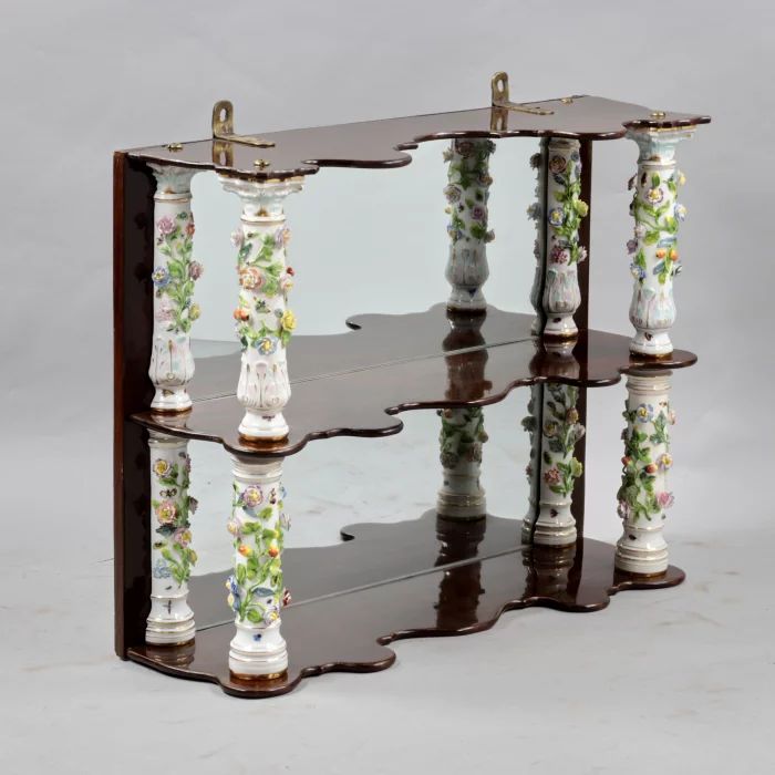 Wooden shelf with Meissen columns. 