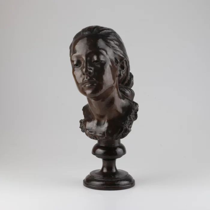 Bronze bust of a woman.